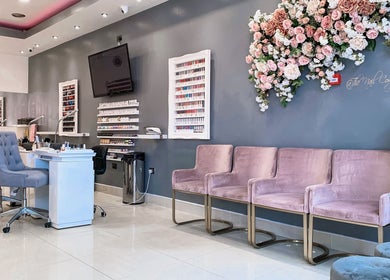 Elegant interior of The Nail Company in London, England, GB with stylish seating and nail polish display.