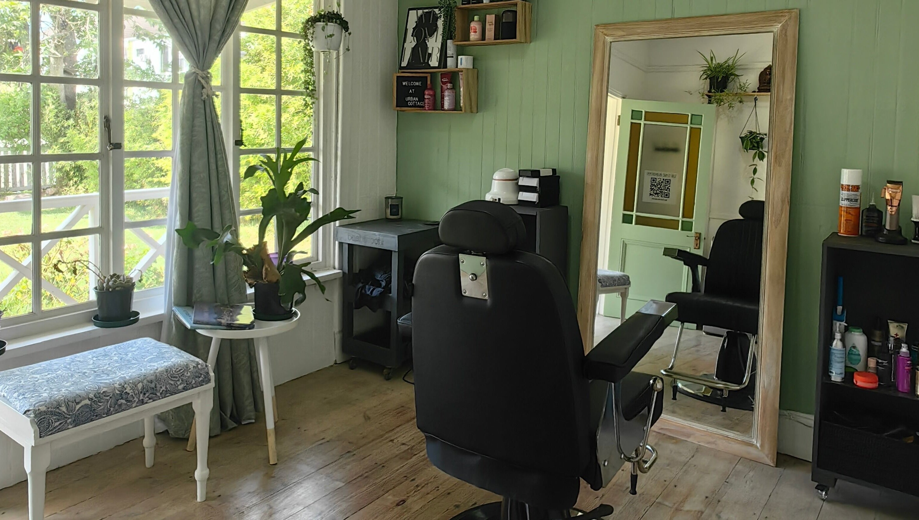Chic salon interior at Urban Cottage, Port Alfred, Eastern Cape, ZA with comfy chair and large mirror.