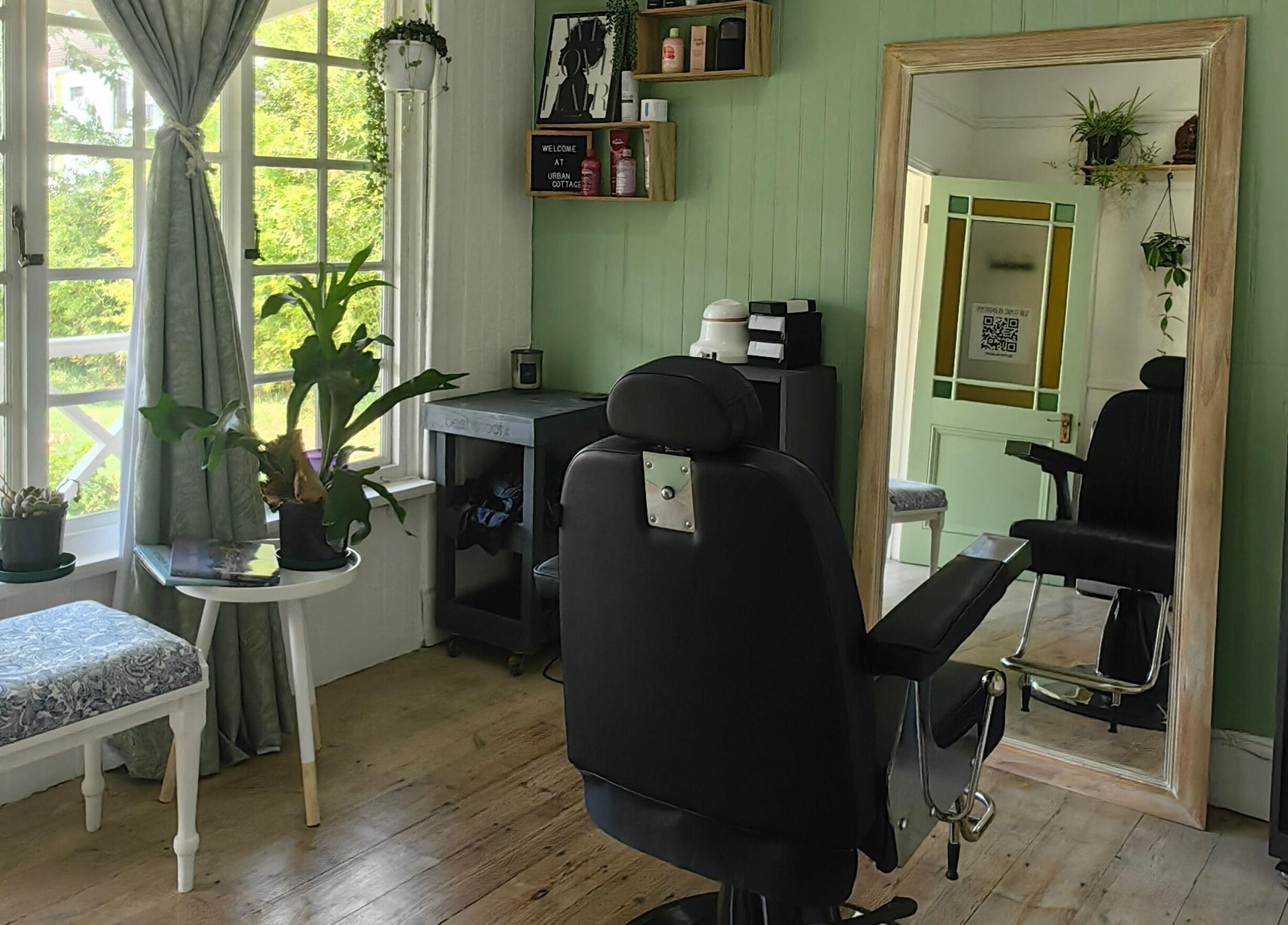 Chic salon interior at Urban Cottage, Port Alfred, Eastern Cape, ZA with comfy chair and large mirror.
