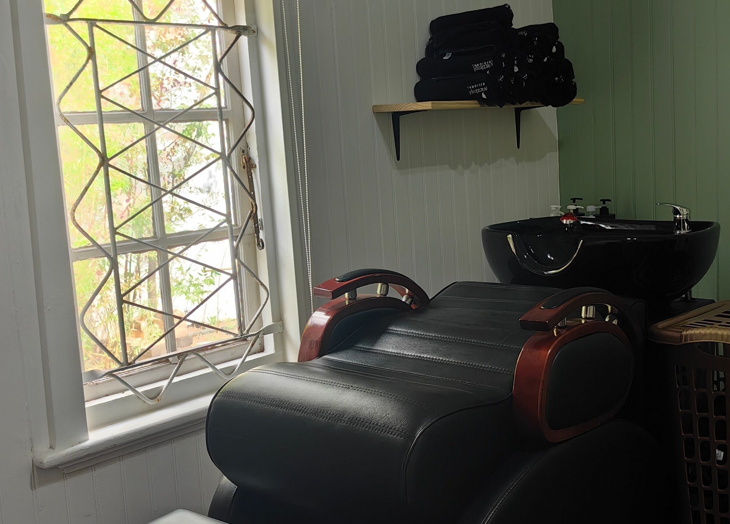 Cozy salon area at Urban Cottage, Port Alfred, with a reclining chair and washbasin enhancing the spa ambiance.