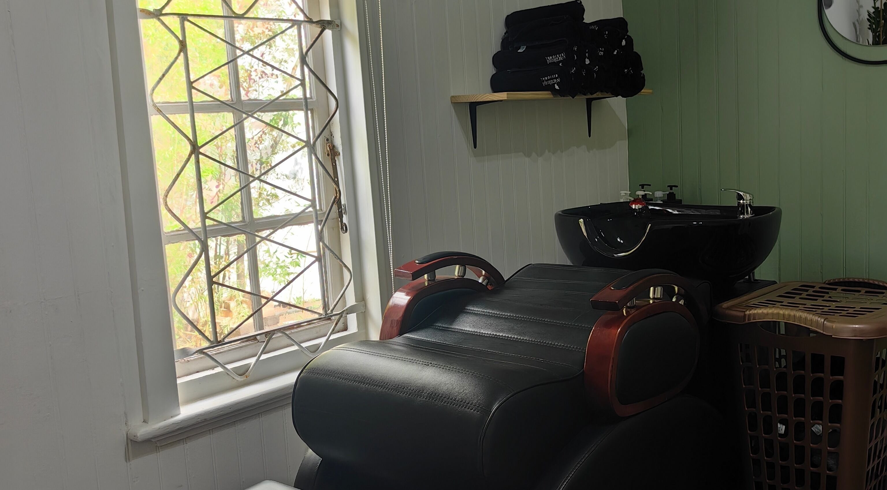Cozy salon area at Urban Cottage, Port Alfred, with a reclining chair and washbasin enhancing the spa ambiance.