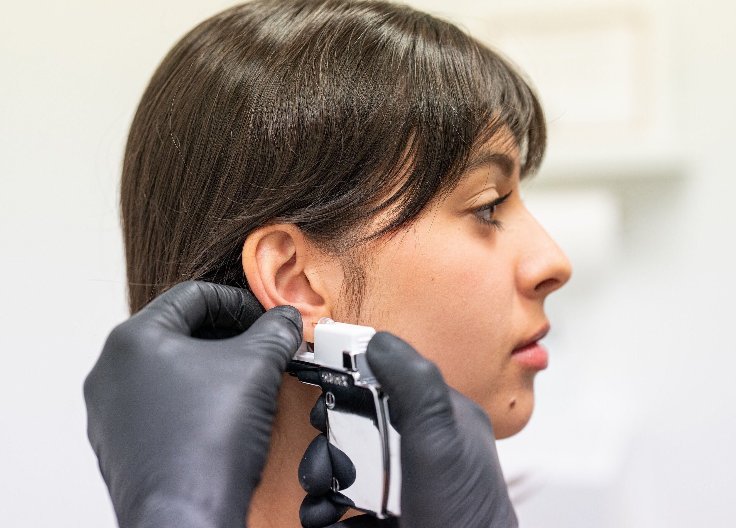 Professional ear piercing at Voka Deka Esthetics Salon, Vancouver, British Columbia, CA with precise technique.