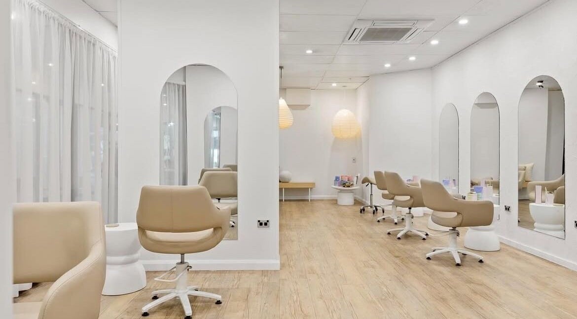 Elegant interior of Livelle Hair Studio, Coffs Harbour, New South Wales, AU with chic styling chairs and mirrors.