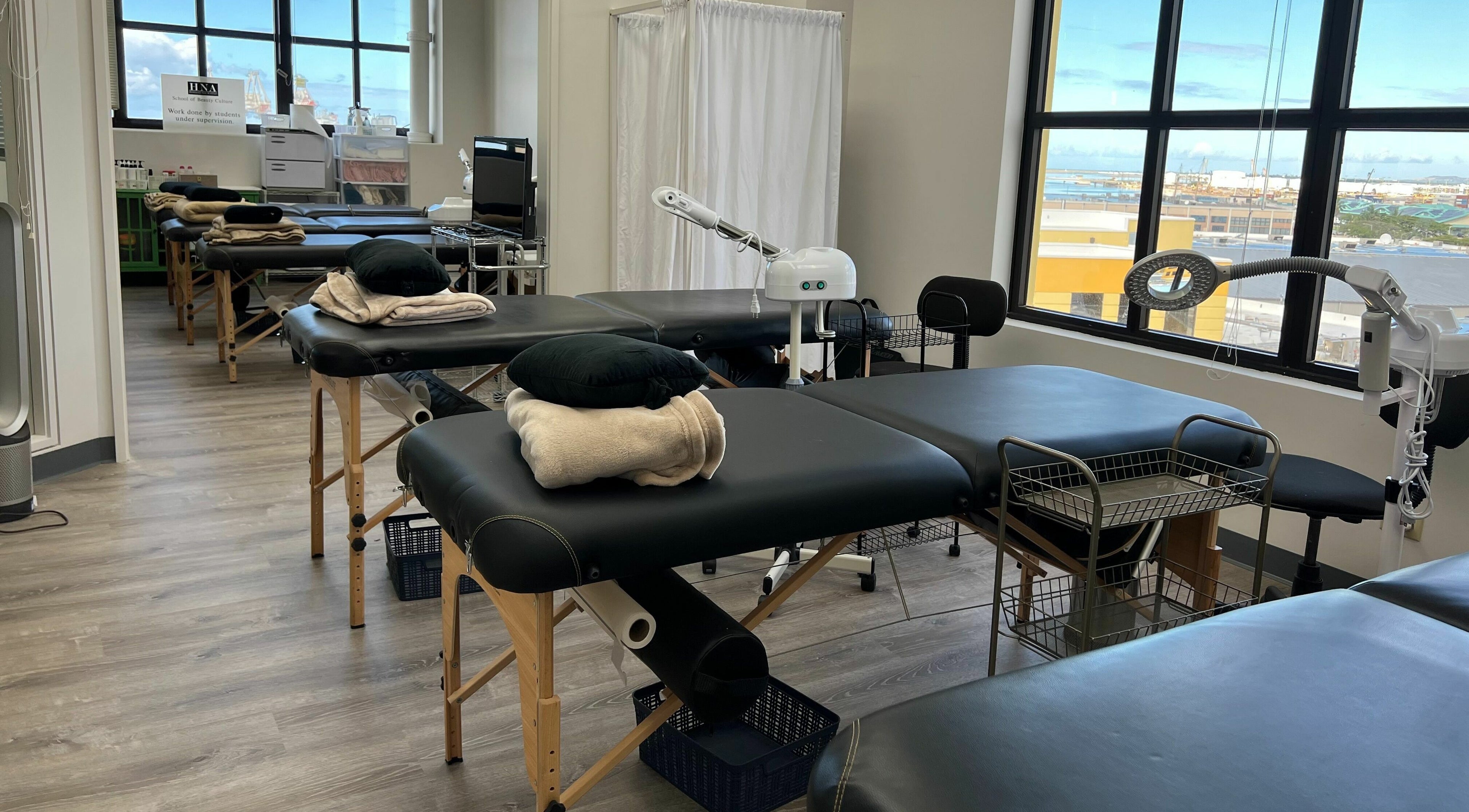 Massage tables at Honolulu Nails & Aesthetics Academy with ocean view, Honolulu, Hawaii, US.