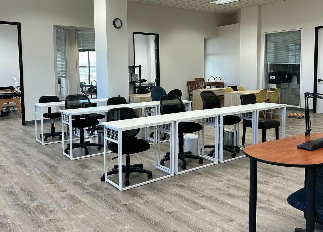 Classroom at Honolulu Nails & Aesthetics Academy, Honolulu, Hawaii, US with desks and chairs.