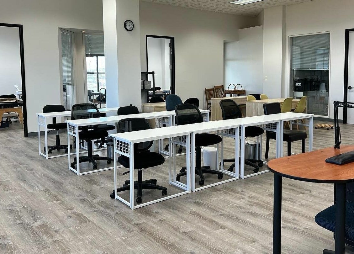 Classroom at Honolulu Nails & Aesthetics Academy, Honolulu, Hawaii, US with desks and chairs.