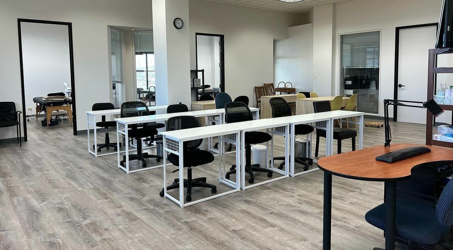 Classroom at Honolulu Nails & Aesthetics Academy, Honolulu, Hawaii, US with desks and chairs.