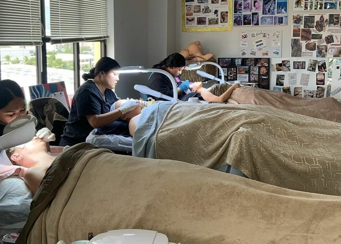 Professionals performing beauty treatments at Honolulu Nails & Aesthetics Academy, Honolulu, Hawaii, US.