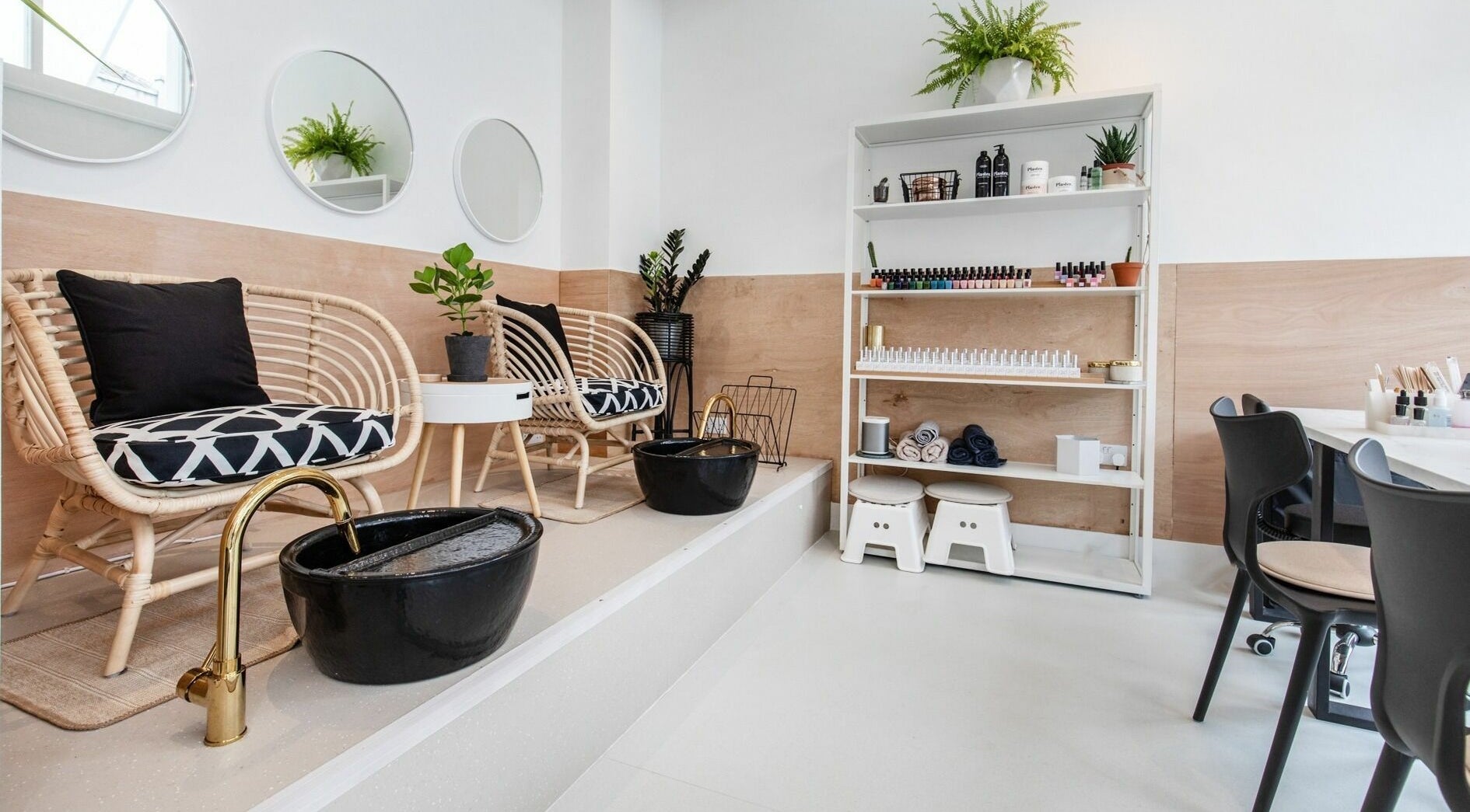 Relaxing spa area at Plaster Beauty in London, England, GB with wicker chairs and a pedicure station.