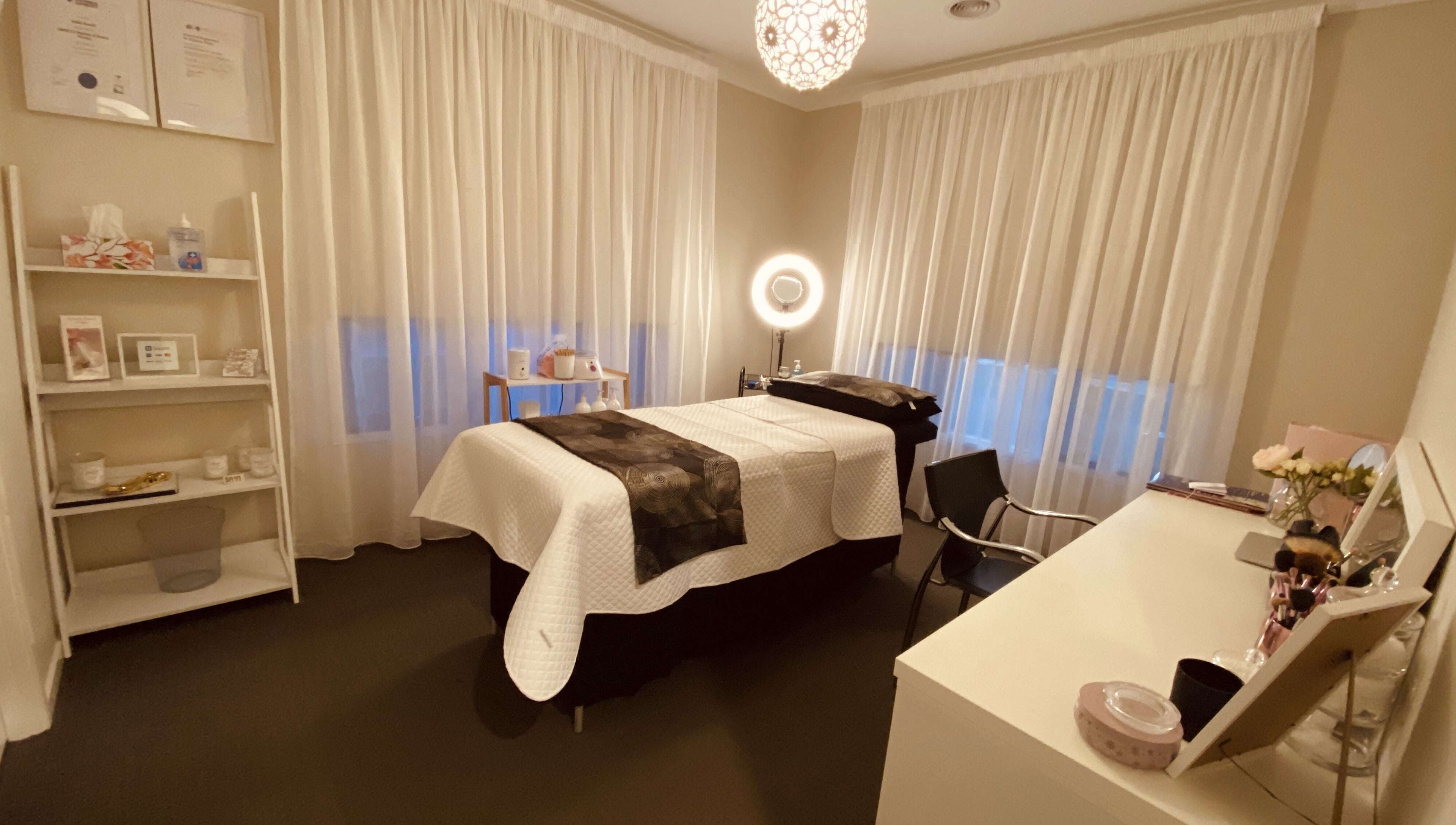 Tranquil treatment room at Blossom Beauty and Spa, Aintree, Victoria, AU featuring a massage table and soft lighting.
