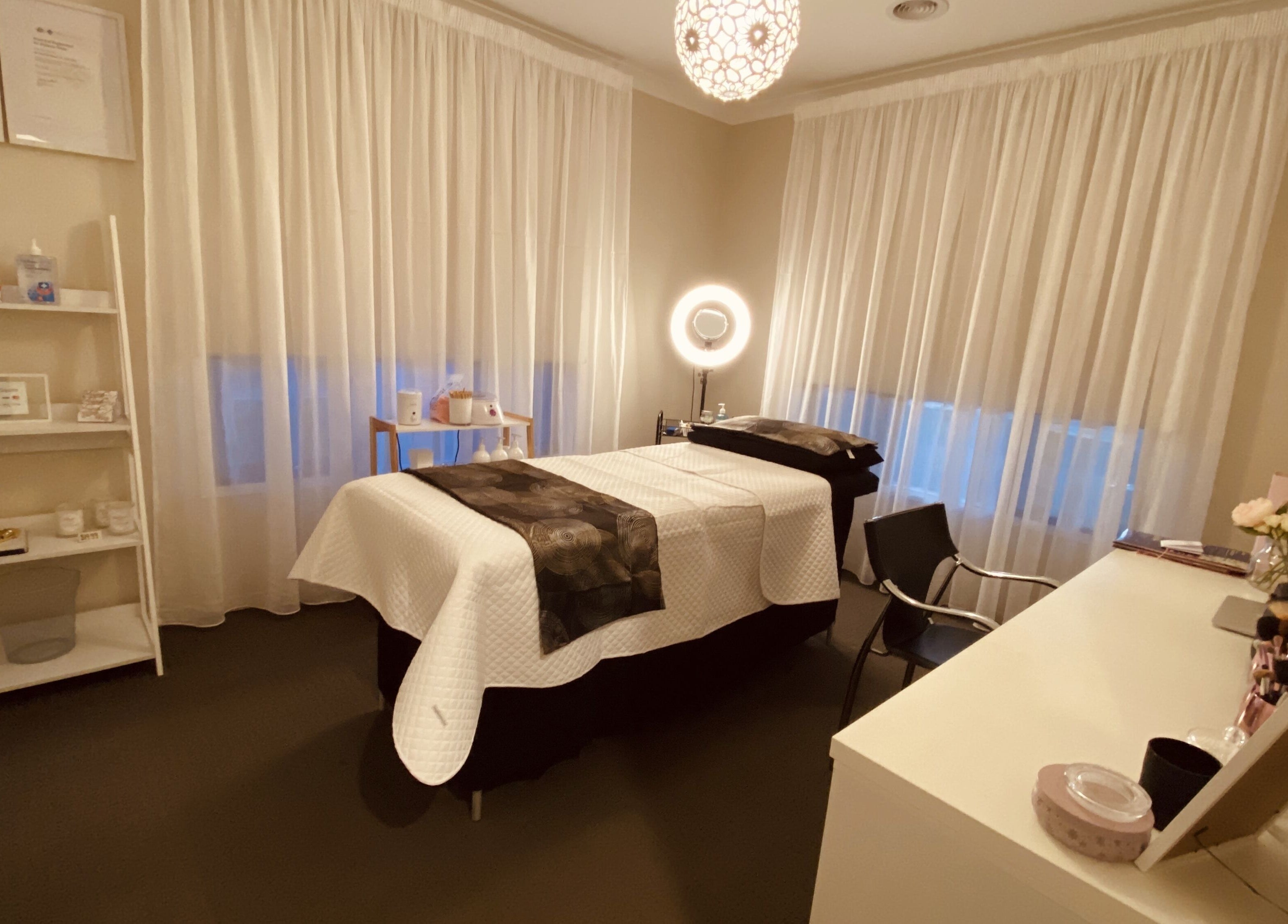 Tranquil treatment room at Blossom Beauty and Spa, Aintree, Victoria, AU featuring a massage table and soft lighting.