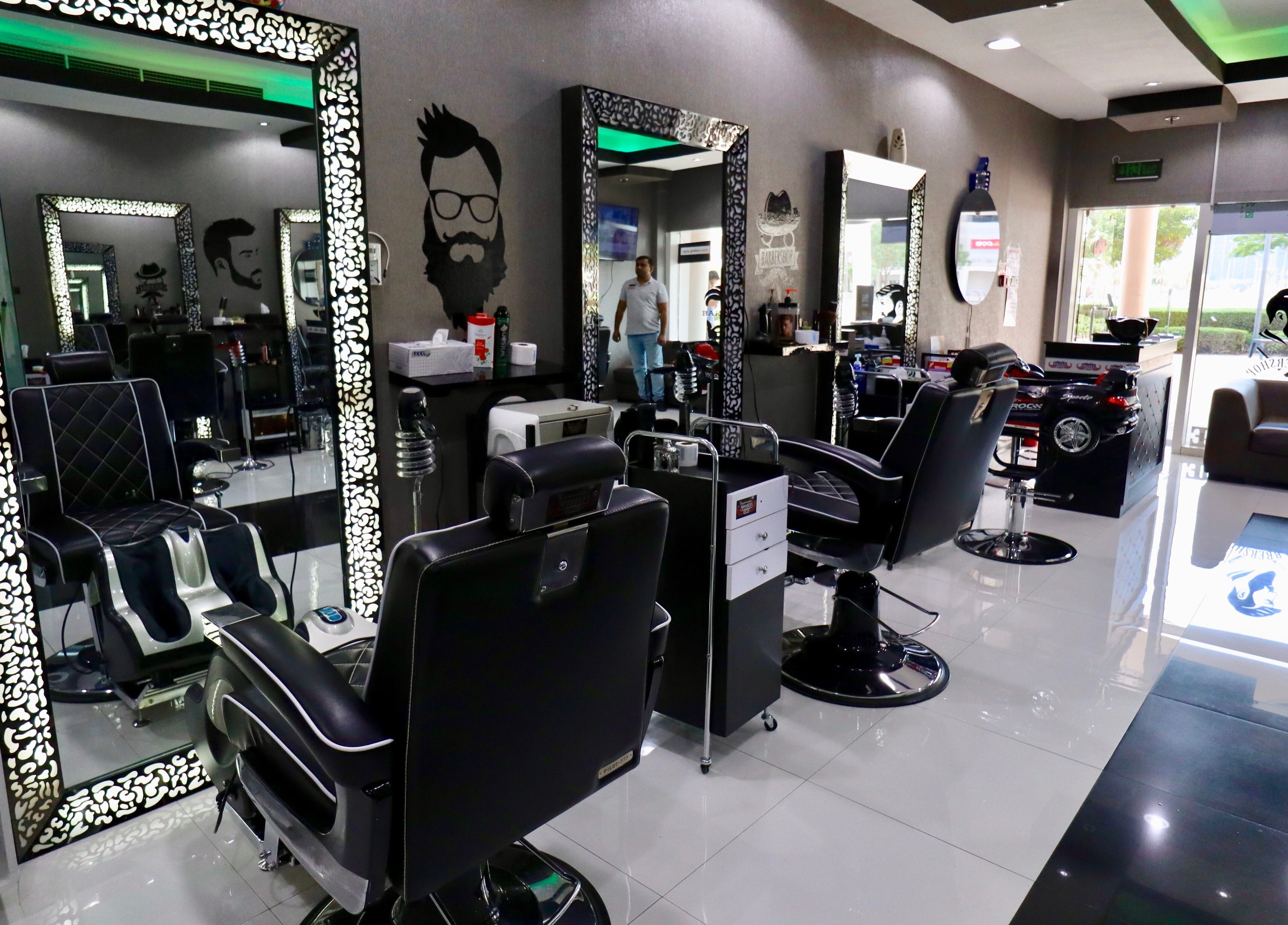 Elegant interior of Cutting Edge Gents Salon | Cluster T in Dubai, AE, showcasing stylish barber chairs and mirrors.
