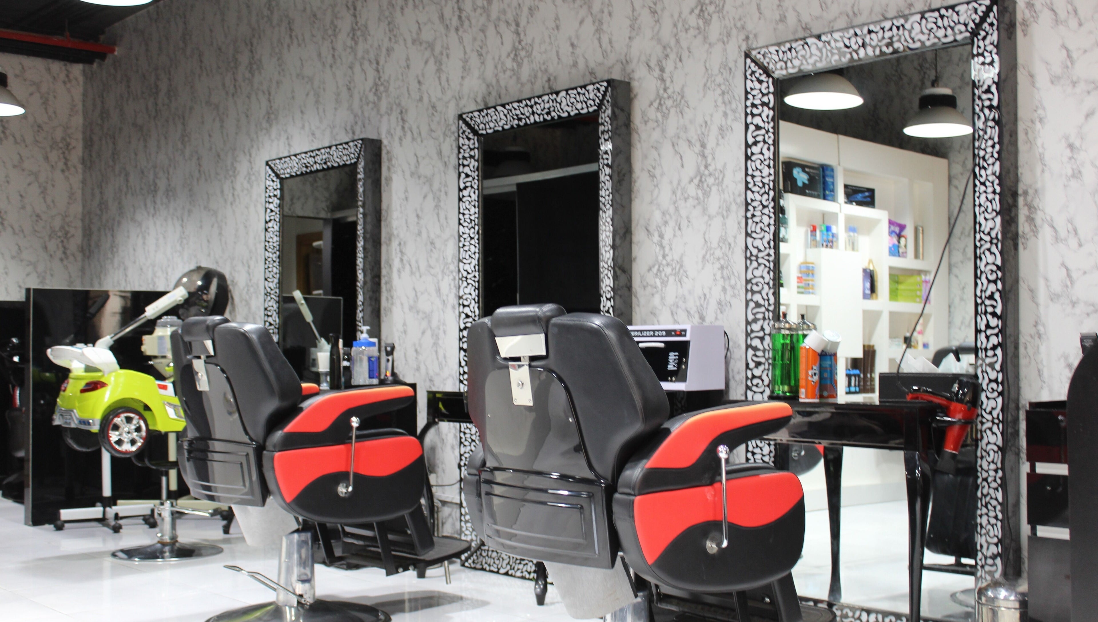 Modern barber chairs at Cutting Edge Gents Salon | Cluster P in Dubai, AE. Chic and stylish interior design.