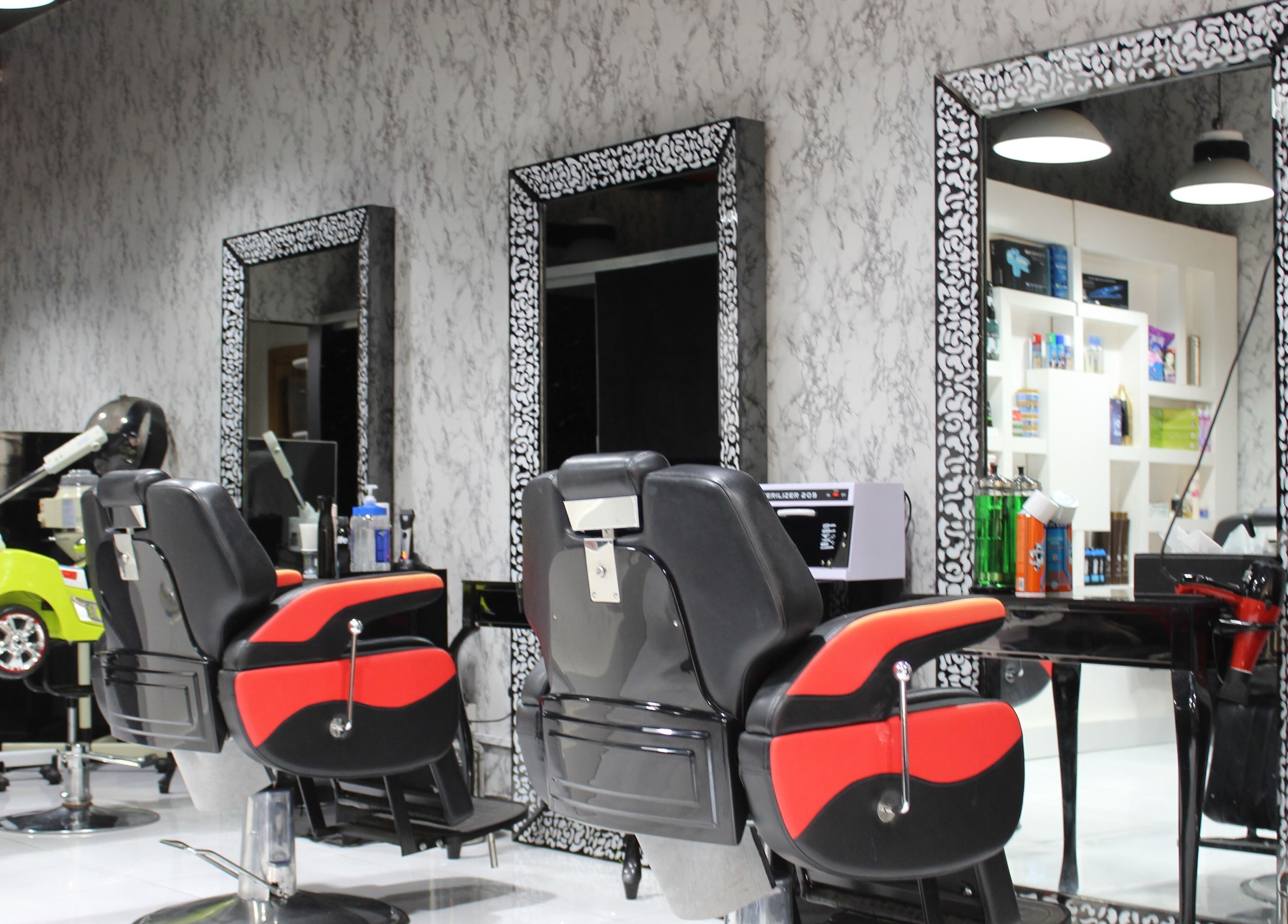 Modern barber chairs at Cutting Edge Gents Salon | Cluster P in Dubai, AE. Chic and stylish interior design.