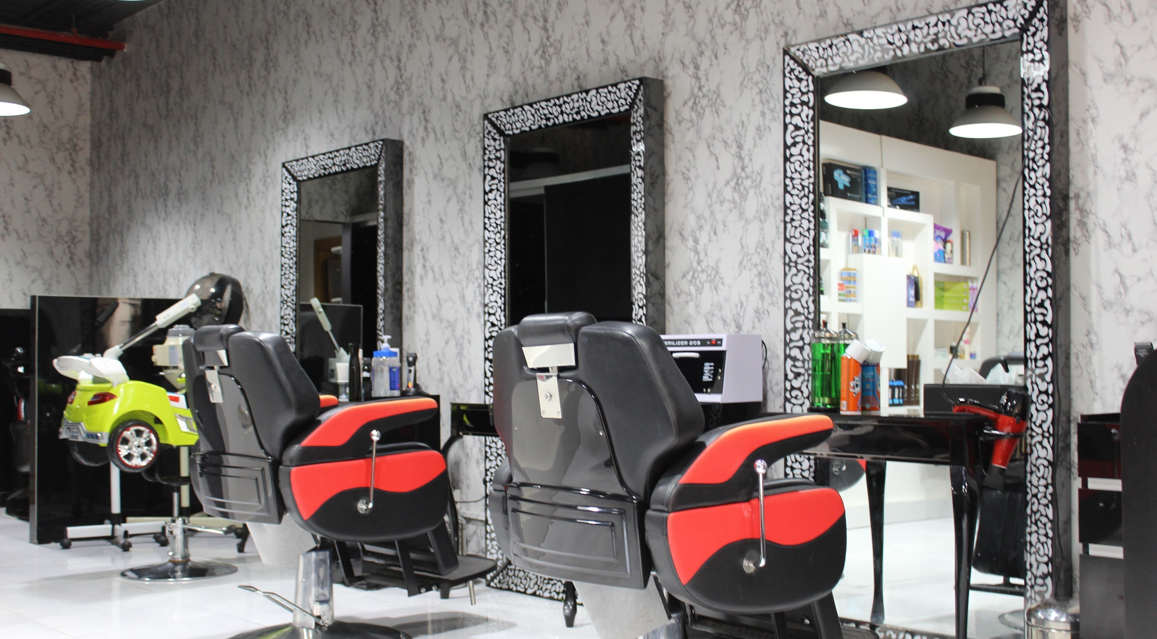 Modern barber chairs at Cutting Edge Gents Salon | Cluster P in Dubai, AE. Chic and stylish interior design.