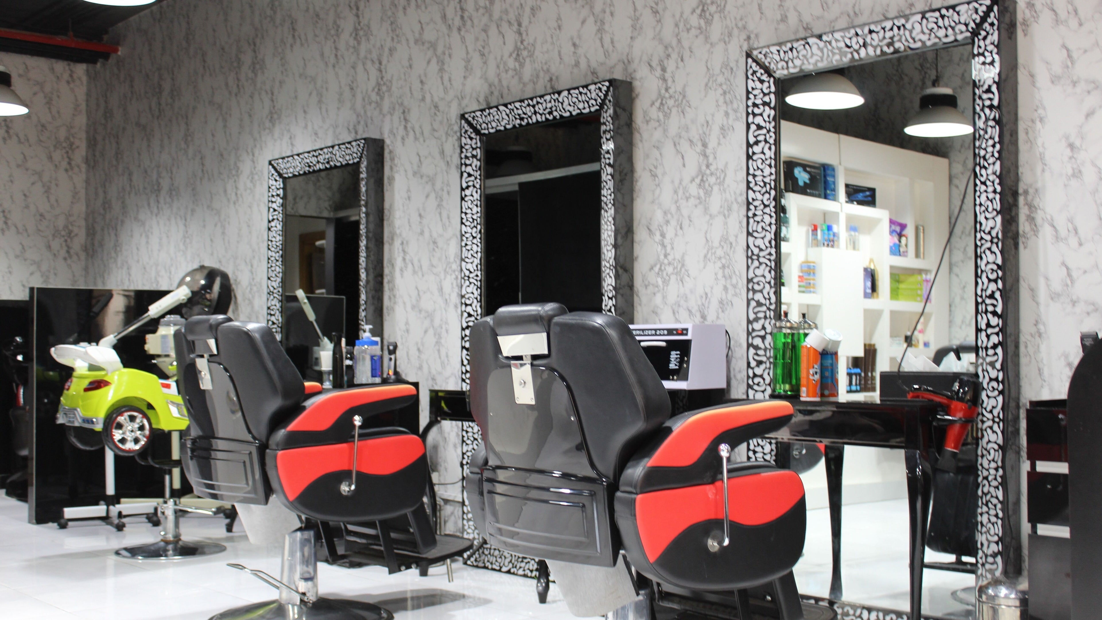 Modern barber chairs at Cutting Edge Gents Salon | Cluster P in Dubai, AE. Chic and stylish interior design.