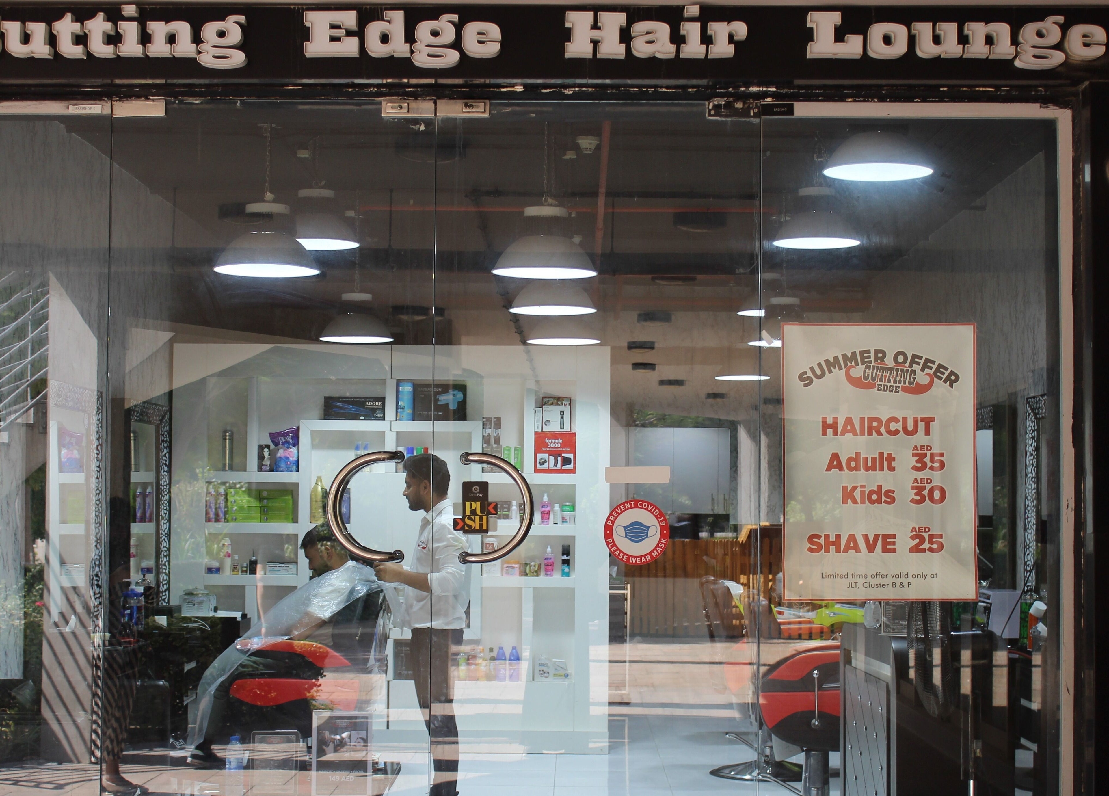 Cutting Edge Gents Salon entrance in Cluster P, Dubai, AE, showcasing modern interior and haircut offers.