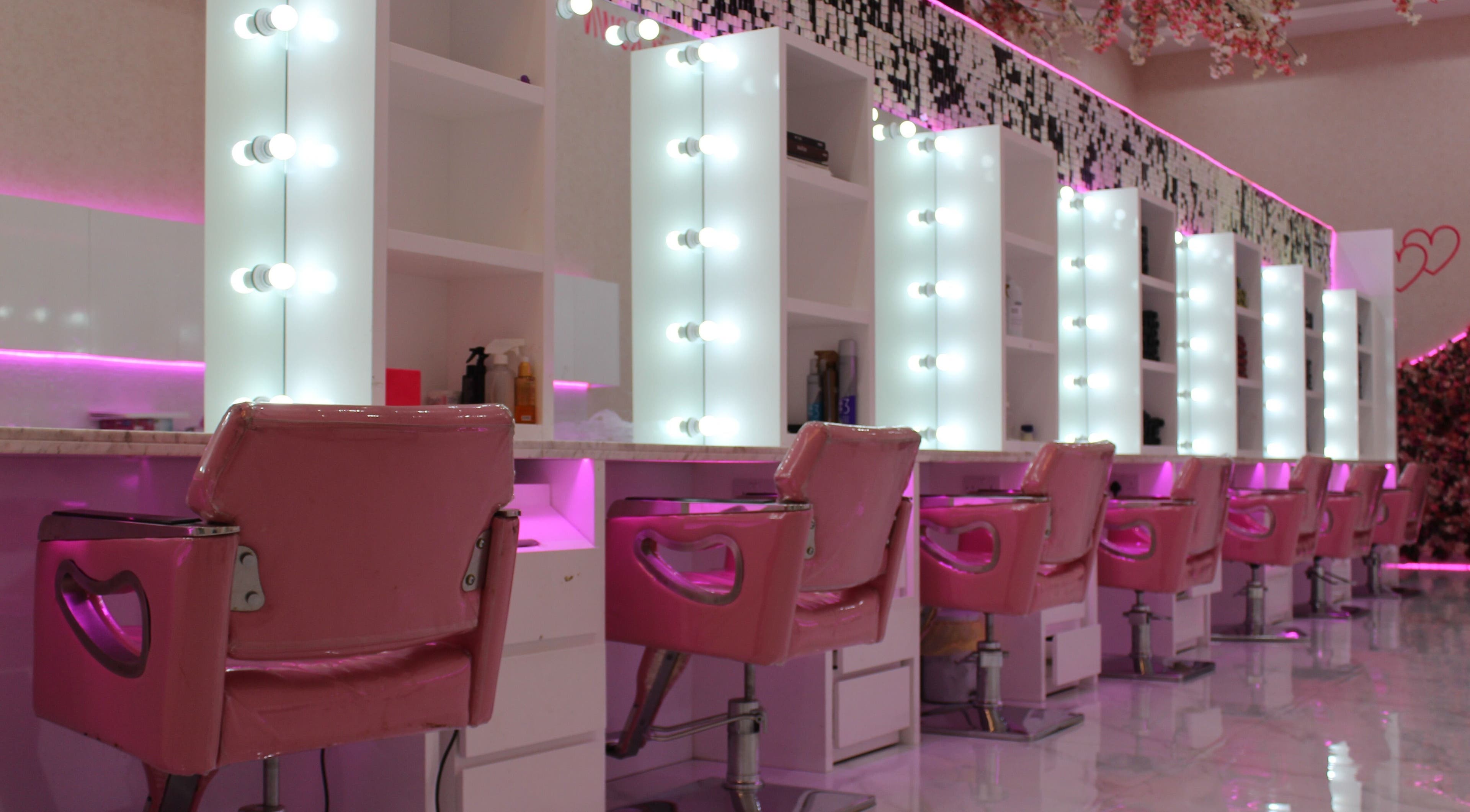 Vibrant salon interior with pink chairs at Cutting Edge Salon & SPA, Silicon Central Mall, Dubai, Dubai, AE.