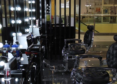 Cutting Edge Gents Salon | IBN Battuta Mall, Dubai, AE: Sleek barber chairs with illuminated mirrors.