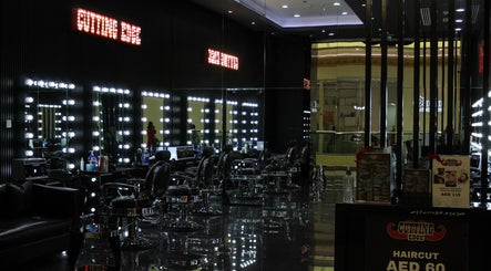 Modern interior of Cutting Edge Gents Salon | IBN Battuta Mall, Dubai, AE with sleek black chairs and mirrors.