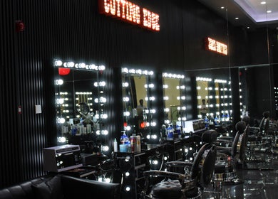 Modern salon interior at Cutting Edge Gents Salon | IBN Battuta Mall, Dubai, AE, featuring illuminated styling mirrors.