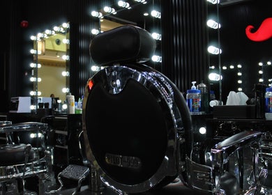 Elegant barber chair at Cutting Edge Gents Salon | IBN Battuta Mall, Dubai, AE, highlighted by modern lights.