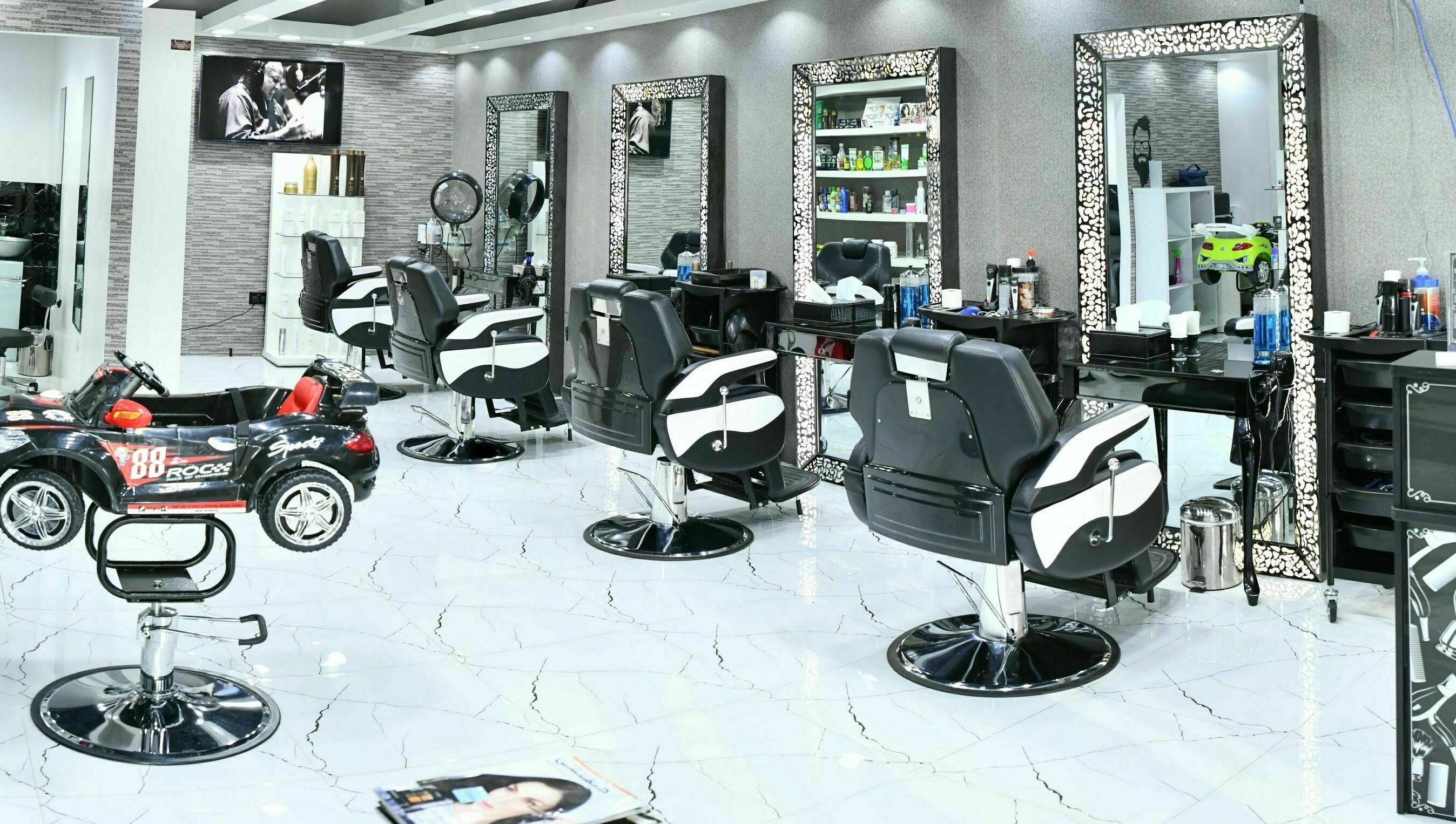 Sophisticated interior of Cutting Edge Gents Salon | Cluster B in Dubai, AE with stylish barber chairs and mirrors.