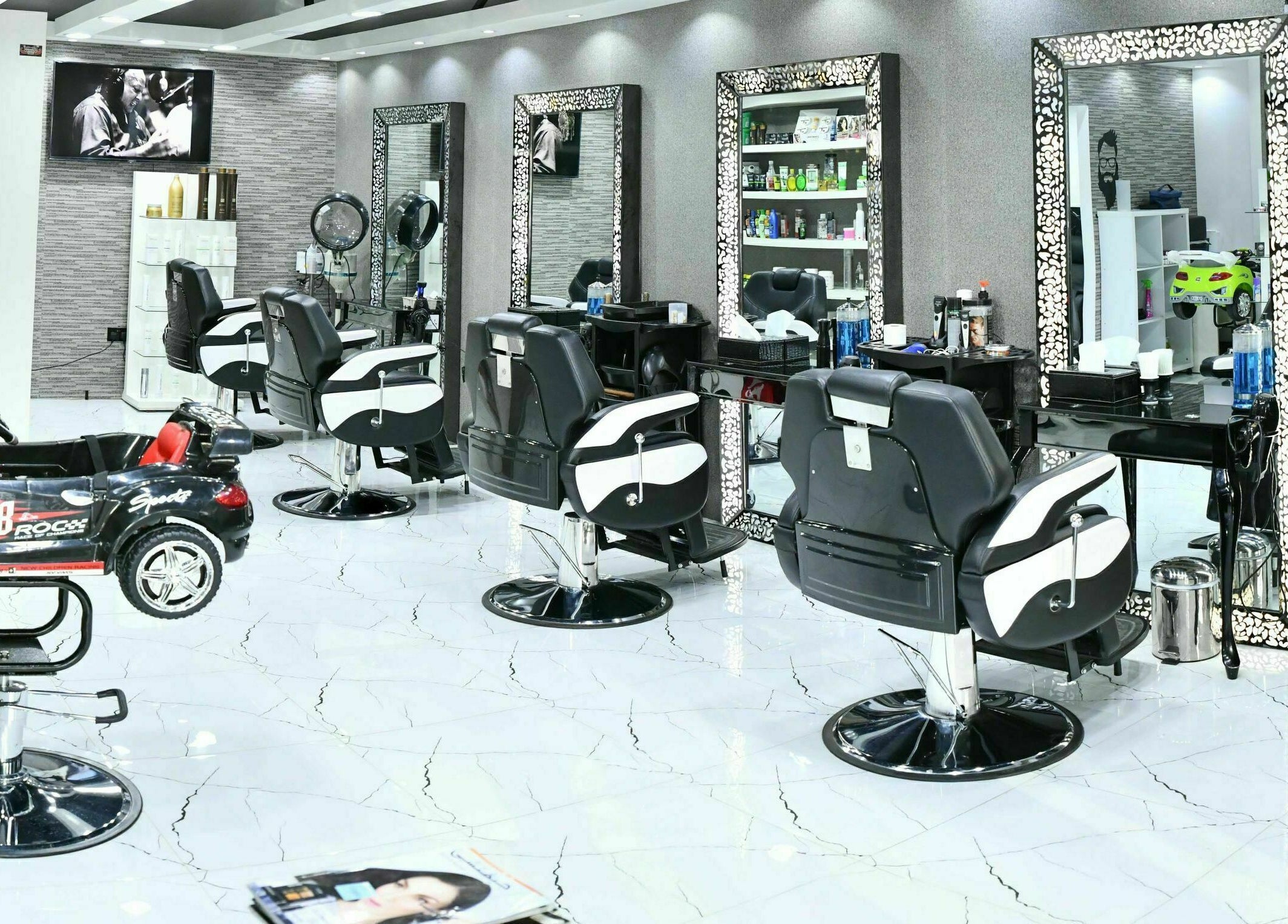 Sophisticated interior of Cutting Edge Gents Salon | Cluster B in Dubai, AE with stylish barber chairs and mirrors.