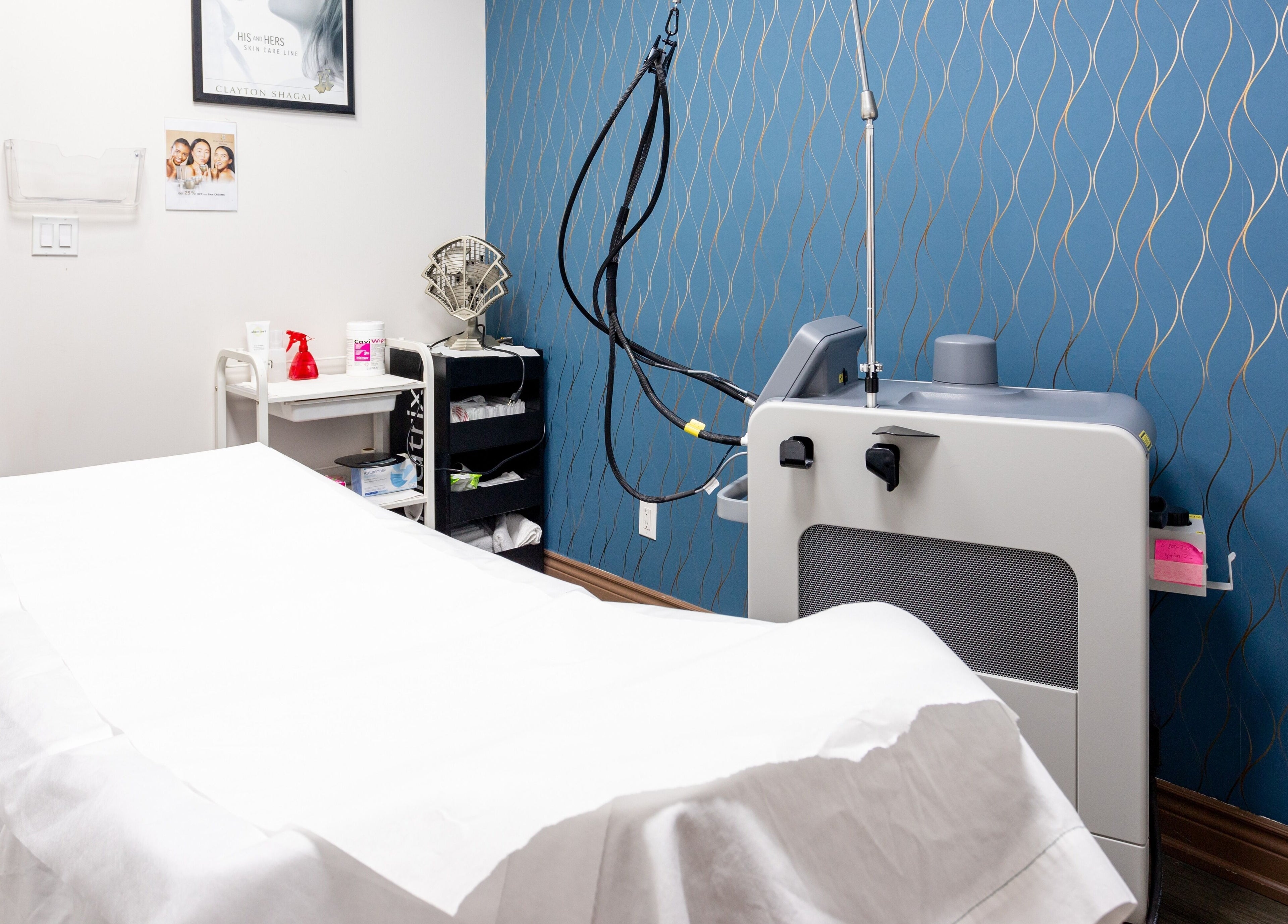 Cozy treatment room at PLC Laser Clinic in Brampton, Ontario, CA, featuring a modern laser machine.