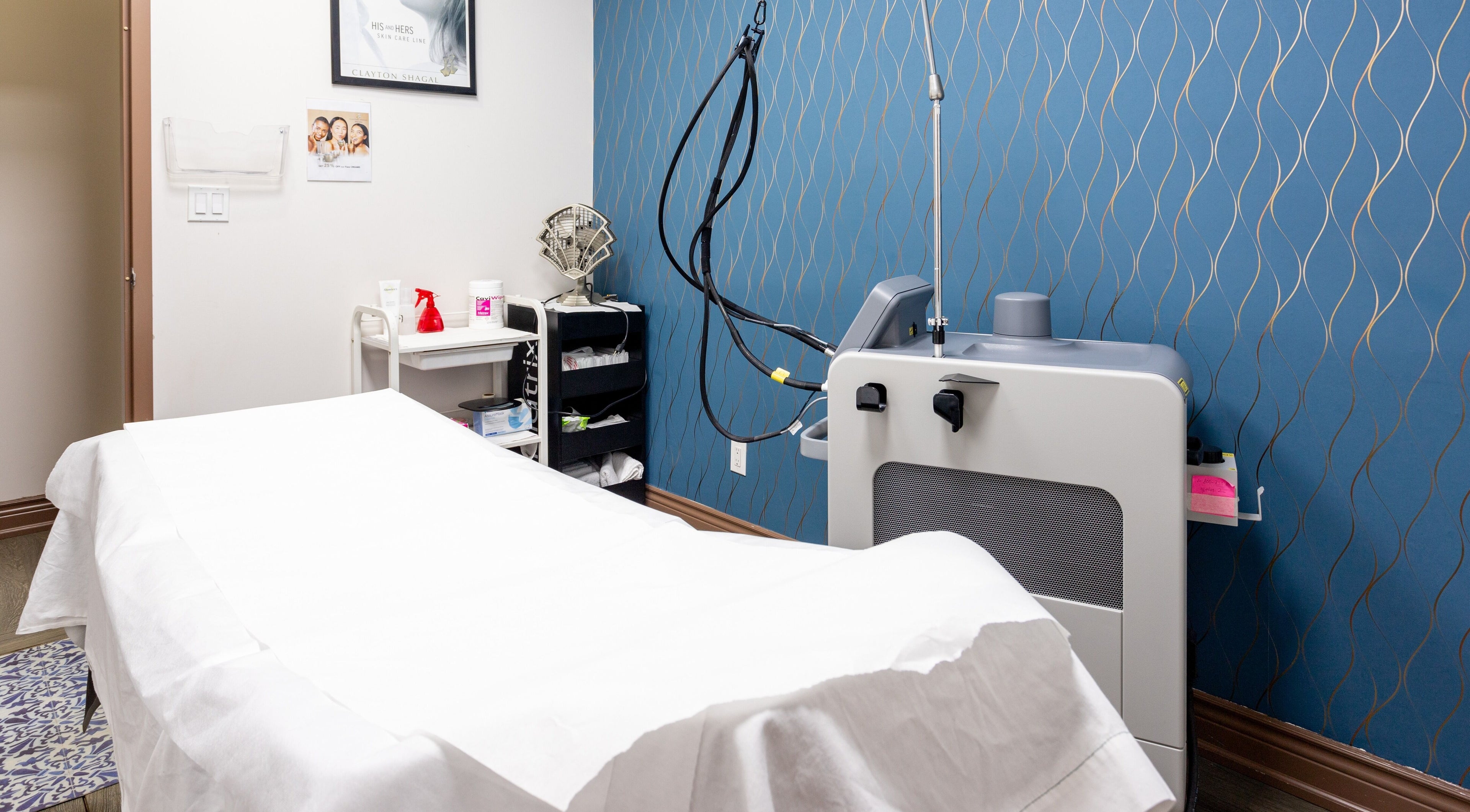 Cozy treatment room at PLC Laser Clinic in Brampton, Ontario, CA, featuring a modern laser machine.