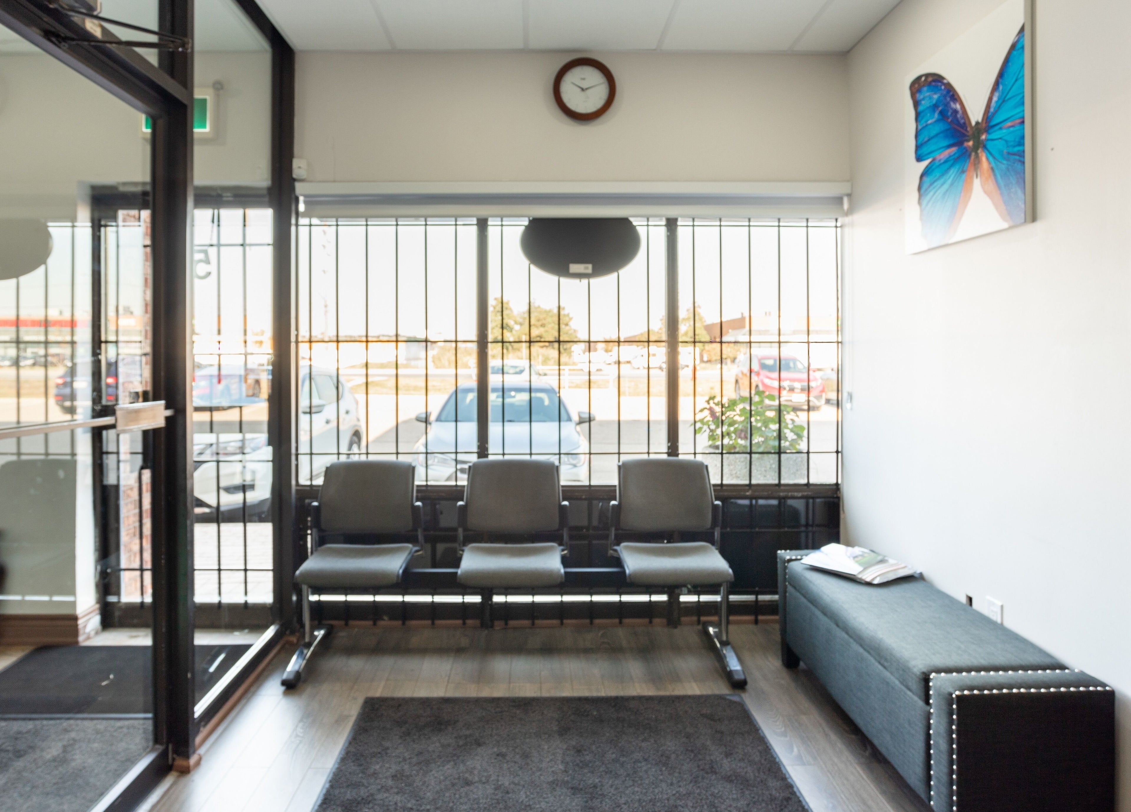 Bright waiting area at PLC Laser Clinic, Brampton, Ontario, CA with seating and butterfly decor.