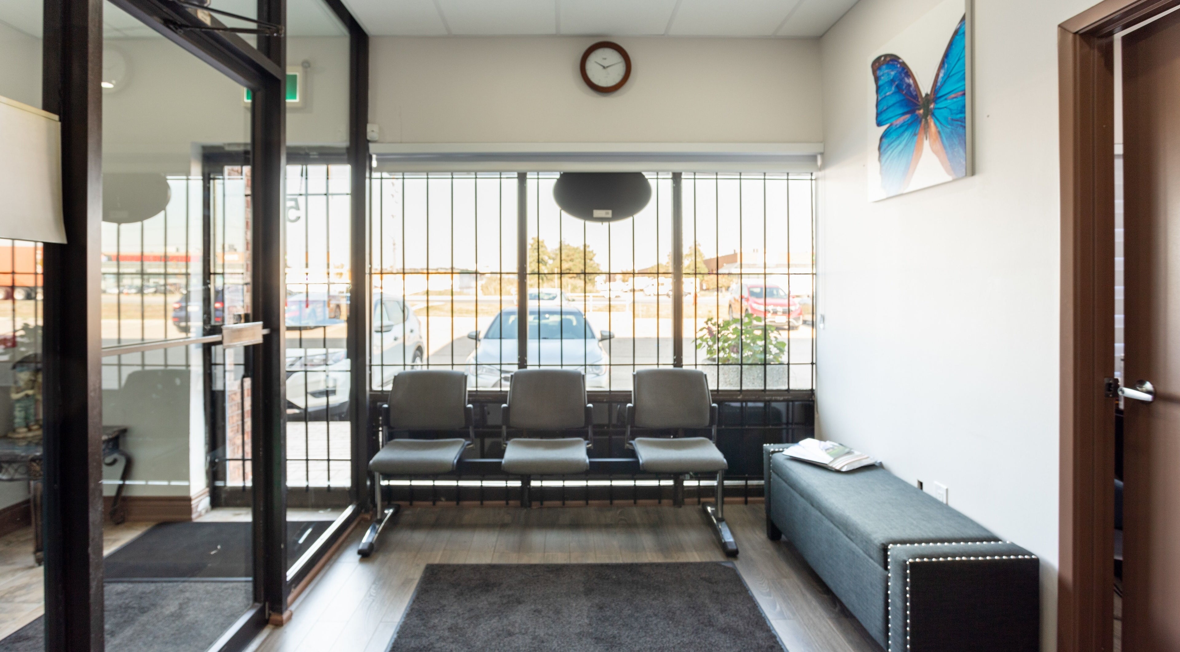 Bright waiting area at PLC Laser Clinic, Brampton, Ontario, CA with seating and butterfly decor.