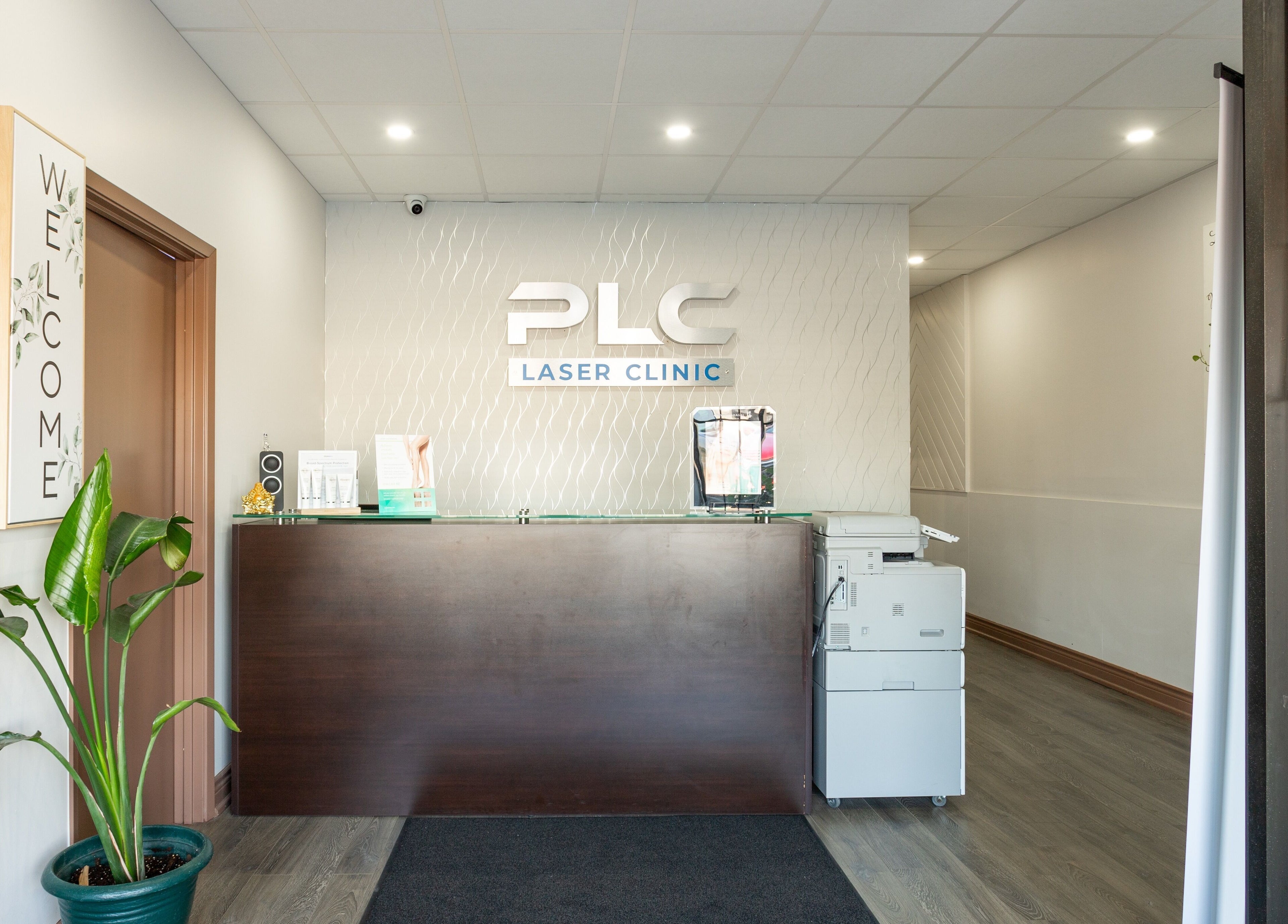 Reception area of PLC Laser Clinic in Brampton, Ontario, CA with elegant decor and welcome sign.