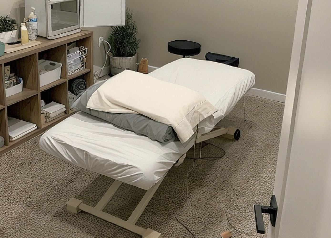 Calming massage room at Clover Therapeutic Wellness Centre in Niagara Falls, Ontario, CA, offering relaxation.