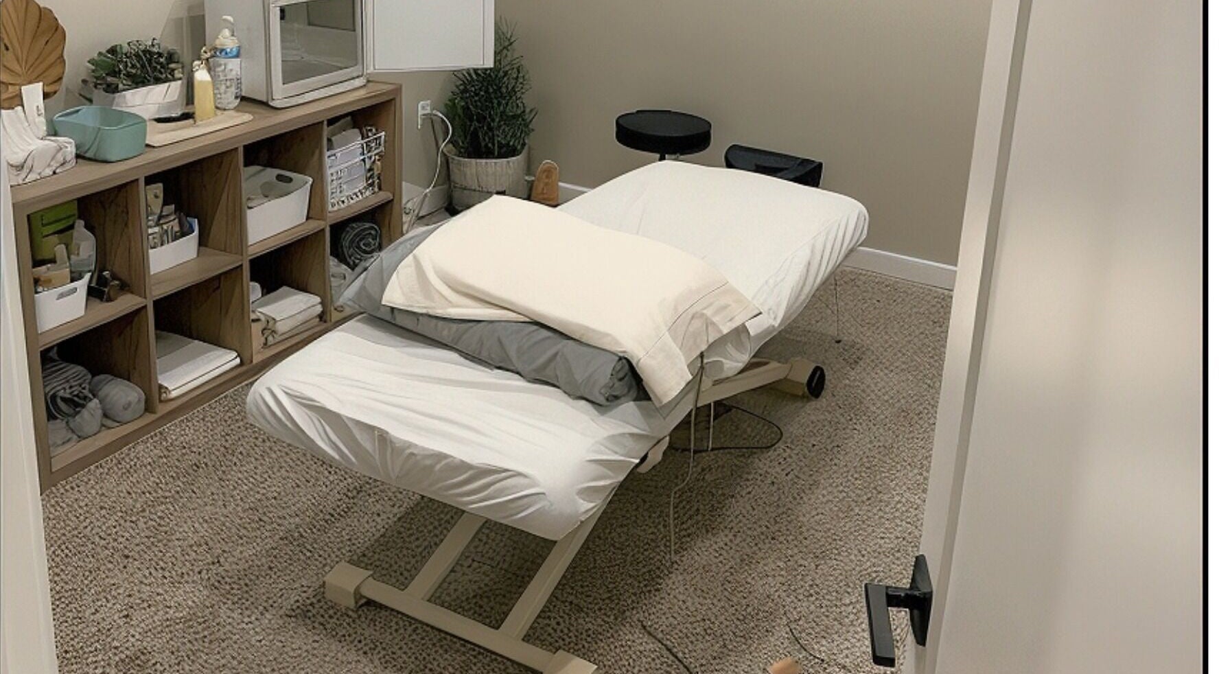 Calming massage room at Clover Therapeutic Wellness Centre in Niagara Falls, Ontario, CA, offering relaxation.