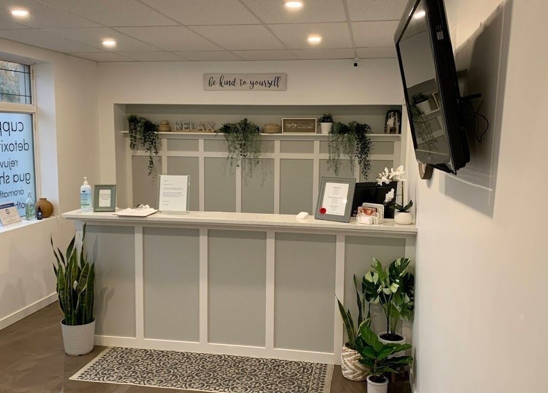 Reception area at Clover Therapeutic Wellness Centre in Niagara Falls, Ontario, CA, adorned with plants and calming decor.