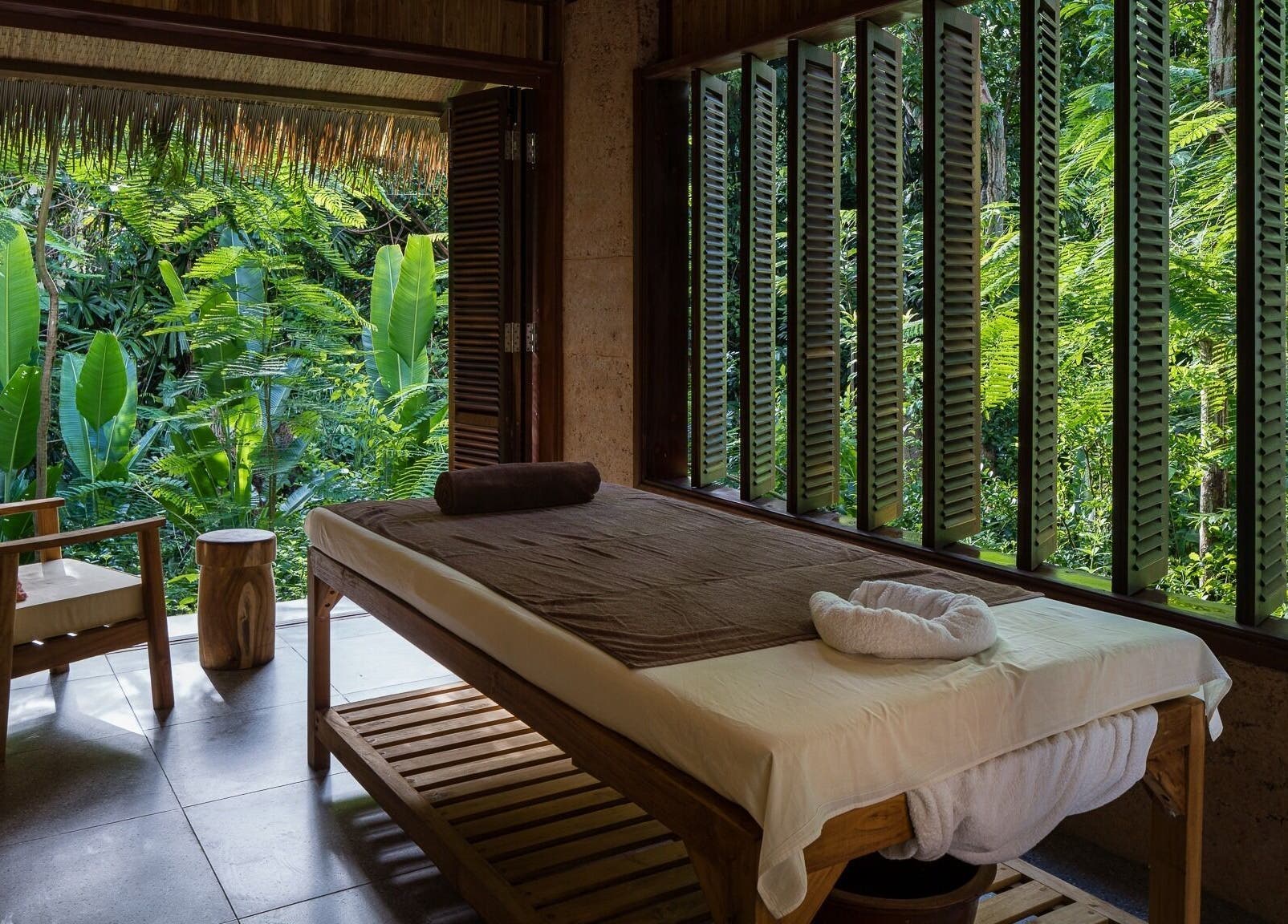 Relaxing massage room at Mango Bay Spa, Phú Quốc, Kiên Giang, VN, featuring lush tropical greenery.