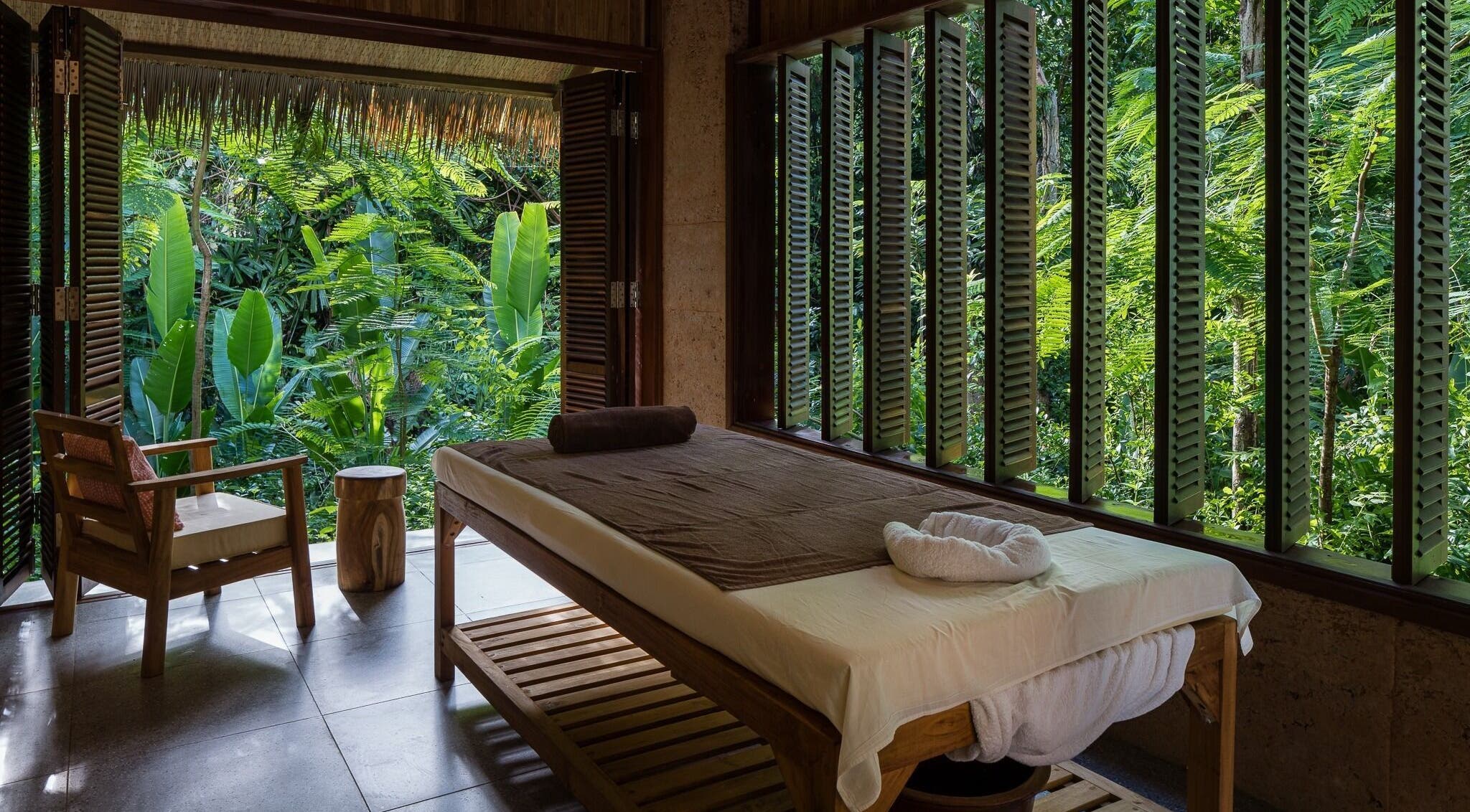 Relaxing massage room at Mango Bay Spa, Phú Quốc, Kiên Giang, VN, featuring lush tropical greenery.