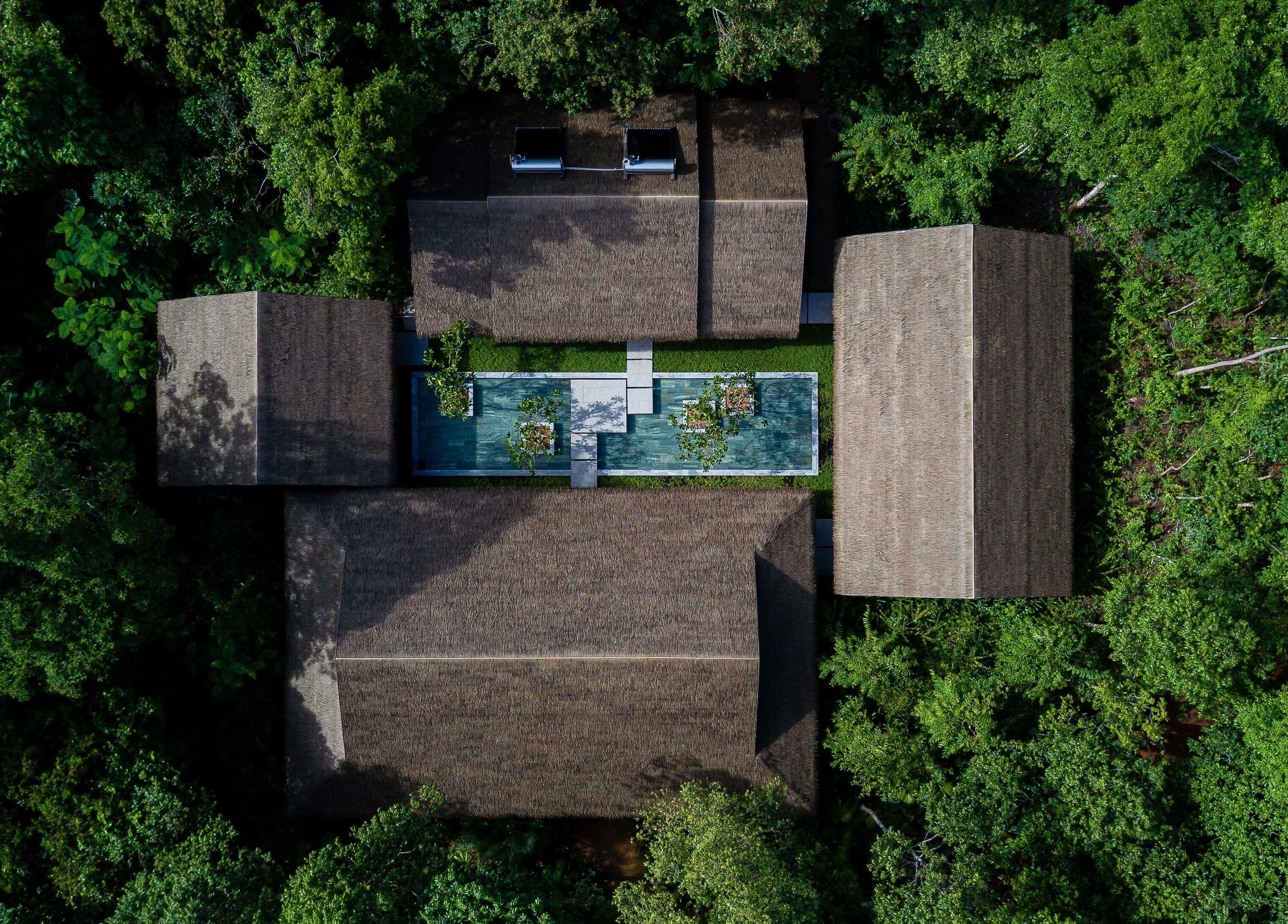 Aerial view of Mango Bay Spa in Phú Quốc, Kiên Giang, VN, showcasing surrounding lush greenery.