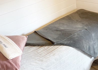 Cozy spa setup at Hive Nails & Beauty, Silkstone, England, GB featuring plush bed and elegant decor.