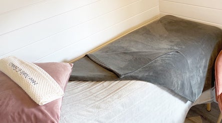 Cozy spa setup at Hive Nails & Beauty, Silkstone, England, GB featuring plush bed and elegant decor.