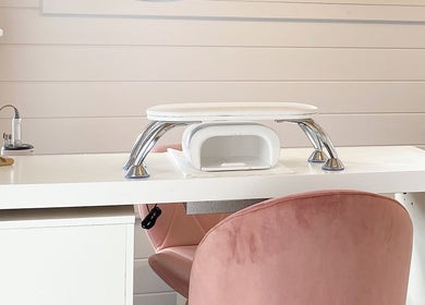 Elegant nail station at Hive Nails & Beauty, Silkstone, England, GB, featuring a sleek desk and plush chair.