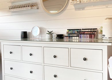 Hive Nails & Beauty interior in Silkstone, England. Sleek dresser with nail polish display and modern decor.