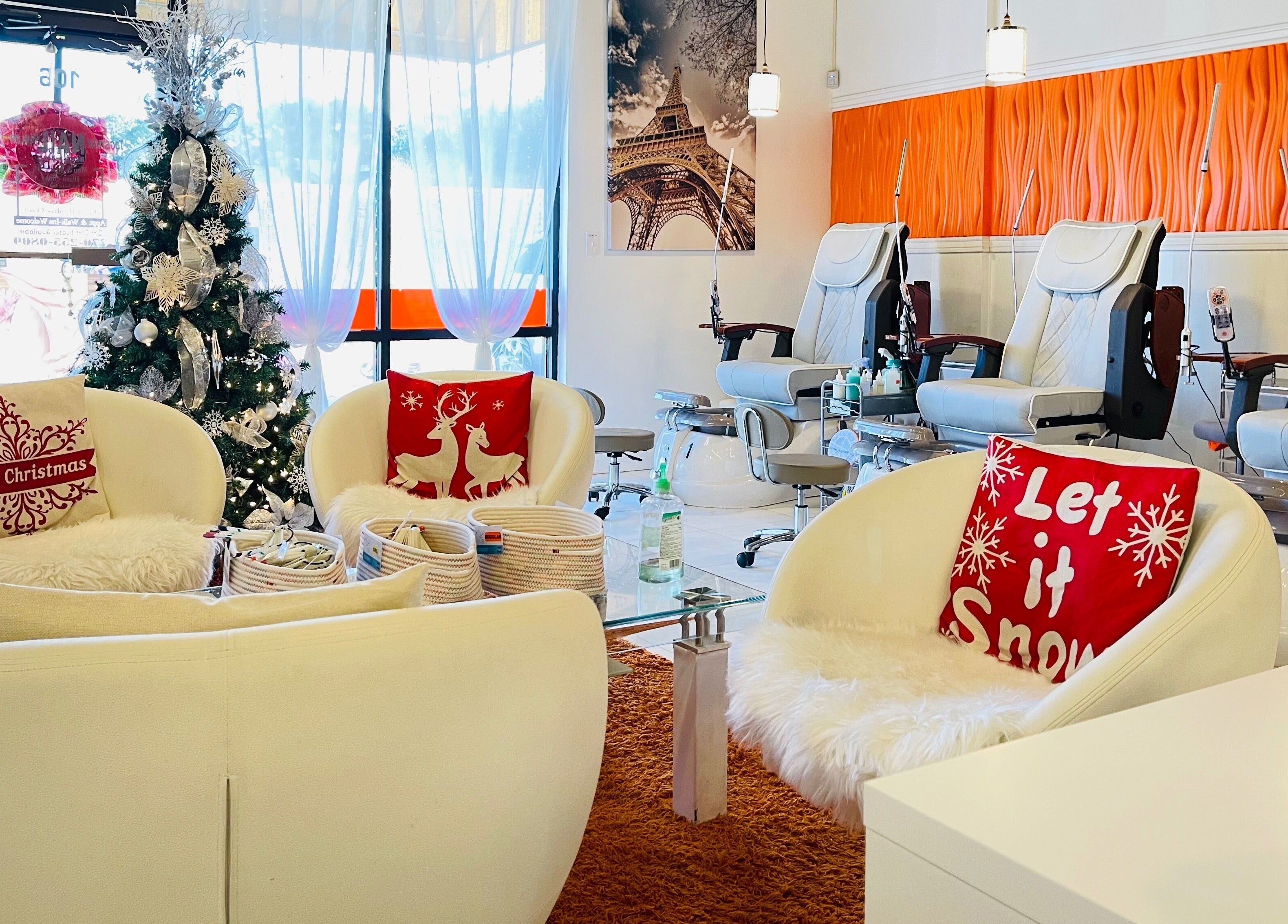 Festive decor at Together Nail Parlor, Suwanee, Georgia, US, featuring cozy chairs and a Christmas tree.