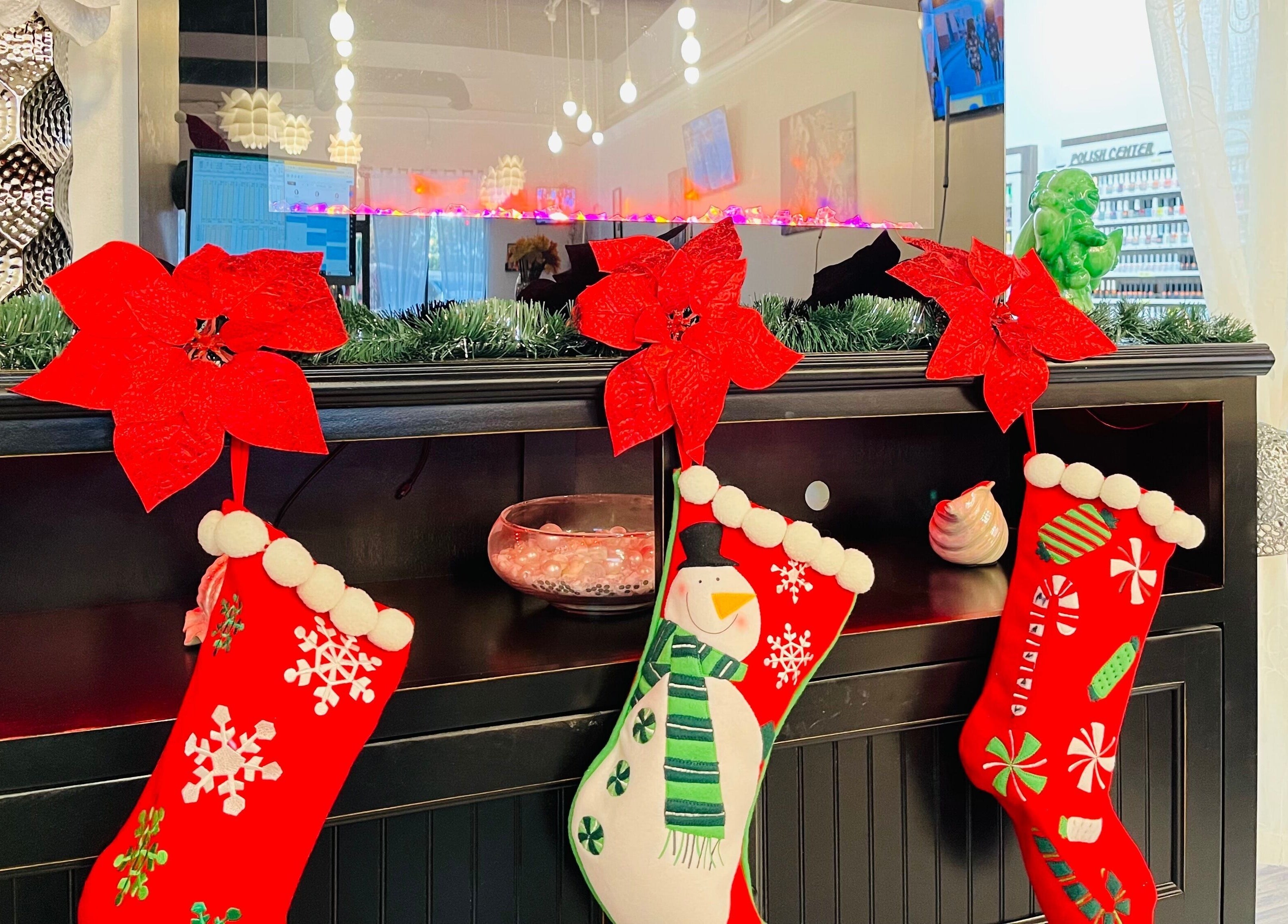 Holiday-themed decor at Together Nail Parlor in Suwanee, Georgia, US with stockings and poinsettias.