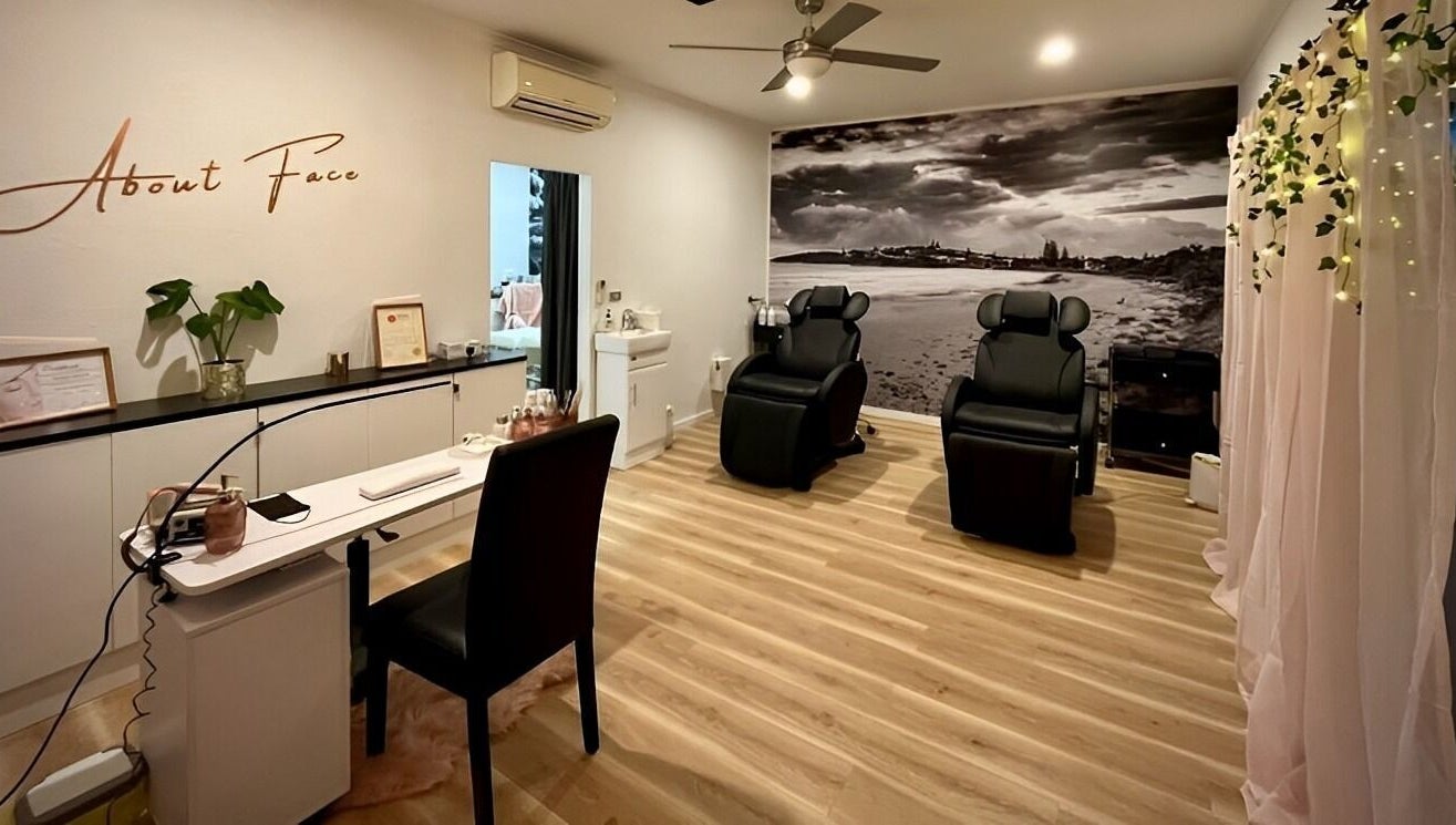 Relaxing spa room at About Face Woopi, Woolgoolga, New South Wales, AU, featuring cozy chairs and elegant decor.