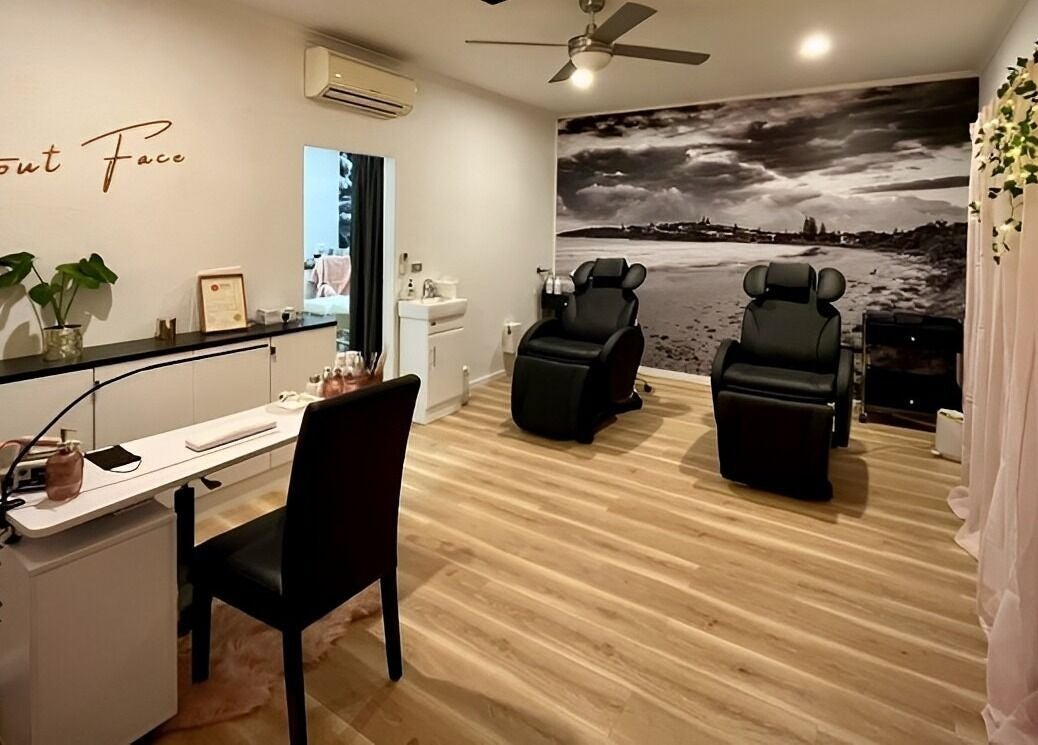 Relaxing spa room at About Face Woopi, Woolgoolga, New South Wales, AU, featuring cozy chairs and elegant decor.