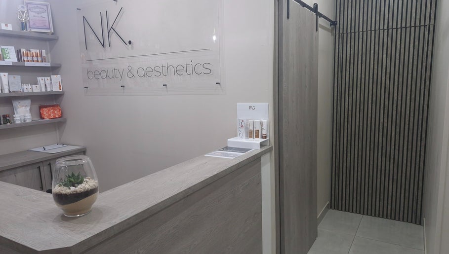 Elegant reception at NK Beauty & Aesthetics in Upington, Northern Cape, ZA. Modern design with skincare products displayed.