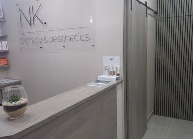 Elegant reception at NK Beauty & Aesthetics in Upington, Northern Cape, ZA. Modern design with skincare products displayed.