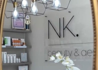 Elegant interior of NK Beauty & Aesthetics in Upington, Northern Cape, ZA, featuring a decorative mirror and products.